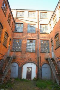 Heritage Impact Assessment at the Button Works Historic Factory Historic brick industrial buildings surrounding a courtyard